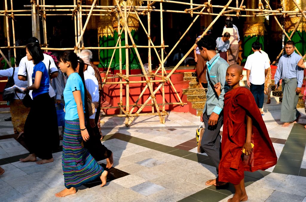 Young monk with their parent at Shwedagon Pagoda in Yangon, Myanmar