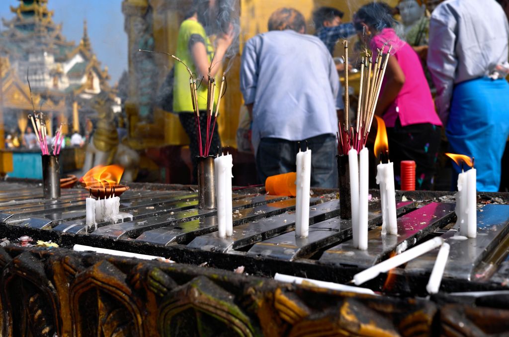 Candles and offerings at Shwedagon Pagoda in Yangon, Myanmar